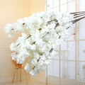Wedding arch decoration with artificial silk cherry blossom branches
