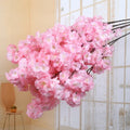 Wedding arch decoration with artificial silk cherry blossom branches